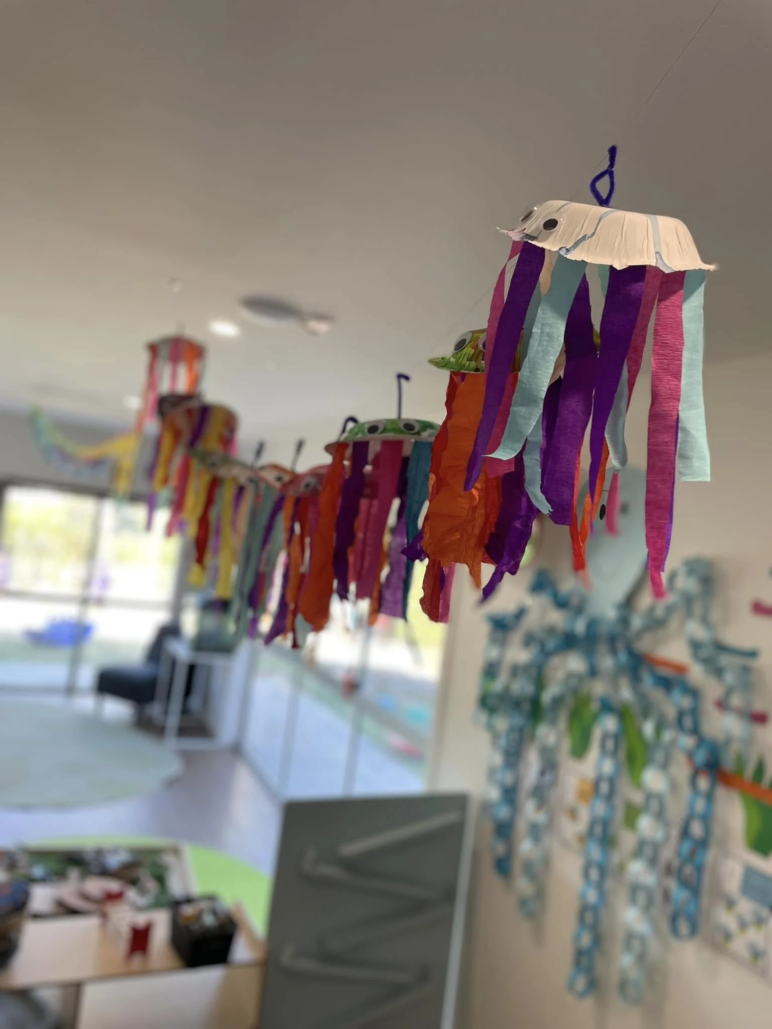 Children's jellyfish craft hanging in the Little Wonders classroom